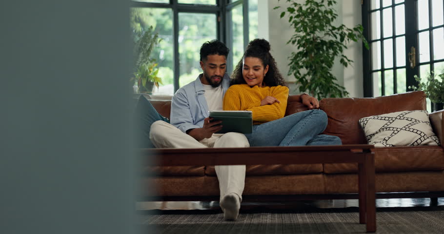 Couple, tablet and relax on sofa with talk, decision and scroll on social media in living room at house. People, man and happy woman with tech, bonding and streaming subscription for movies at home