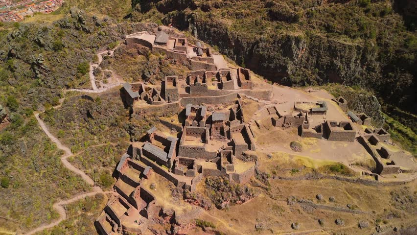 Pisac’s iconic Inca terraces and stone ruins, showcasing the dramatic elevation and breathtaking Sacred Valley landscape in Peru - aerial orbit shot