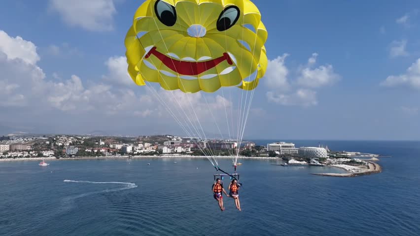 Men and woman parasailing  .