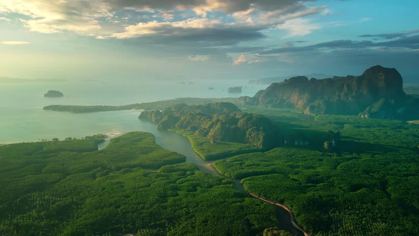 Golden hour aerial of Krabi s lush mangroves, winding rivers, and limestone cliffs leading to the sea. Ideal for cinematic travel promos, eco-tourism visuals, or nature branding.