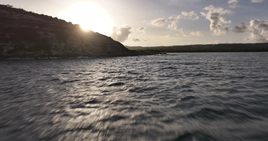 A cinematic drone footage capturing a glowing sunset over Vieques Island in Puerto Rico