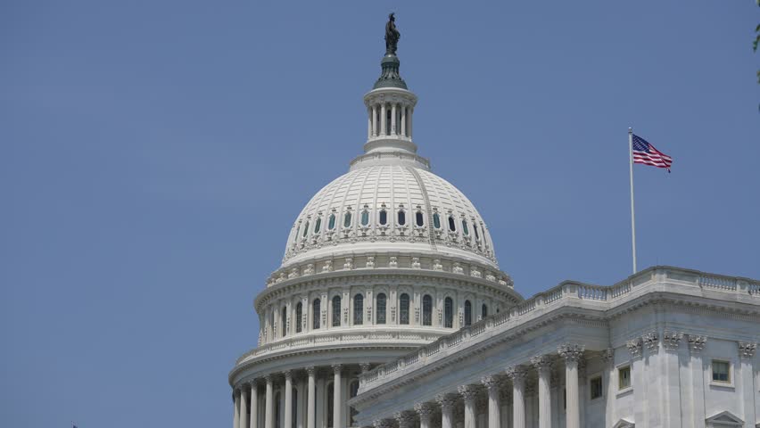 US Congress, Capitol. Washington DC the Capitol skyline with US Flag. Senate and House USA building near American Flag. District of Columbia. The Capitol building with USA flag.