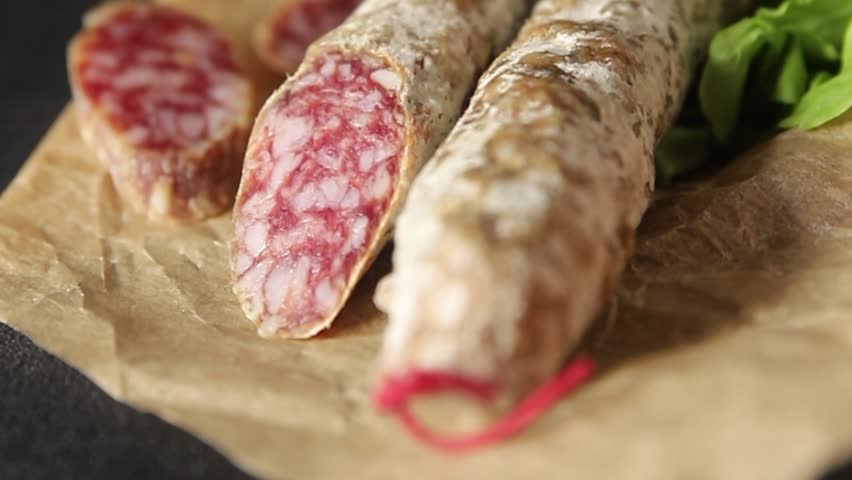 Sausage dry-cured pork meat smoked food fresh gourmet food background on the table rustic food top view copy space