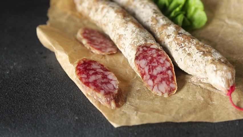 Sausage dry-cured pork meat smoked food fresh gourmet food background on the table rustic food top view copy space