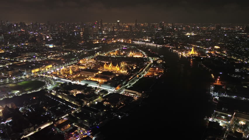 Aerial view of royal Grand palace and Wat Arun at night in Bangkok, Thailand, 4k