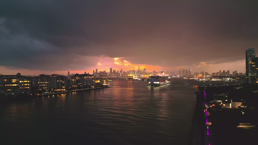 Miami Beach, South Beach at night with dramatic sky. Miami seaside at dusk. Aerial view of evening Miami Beach and cityscape. Coastline of Miami Beach sunset shot from the air drone.