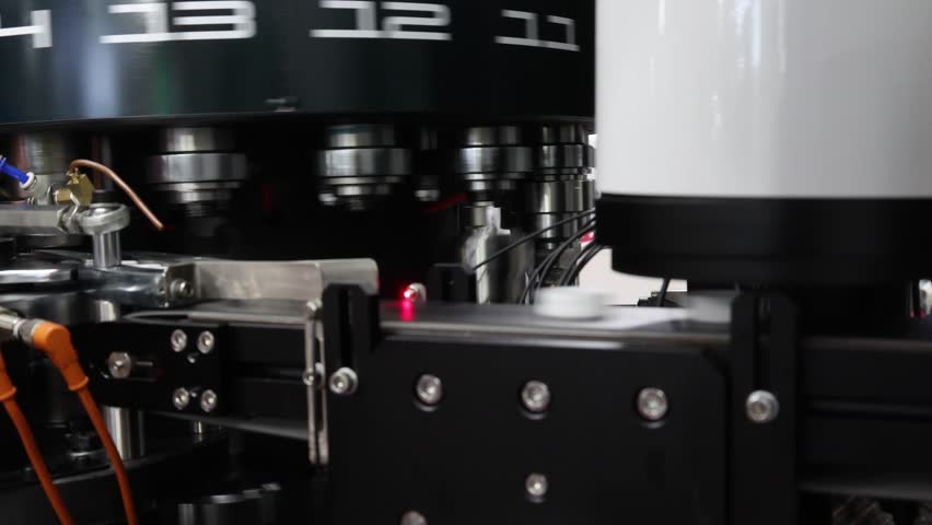 Plastics Cap making. Demo of Plastic caps moving through automated assembly machine in modern factory. Precision engineering and robotic in industrial plastic packaging and bottle cap manufacturing.