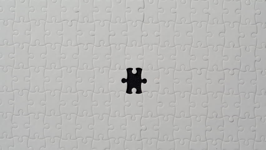Hand putting last puzzle piece finishing closeup. White jigsaw being assembled. Completing task. Full understanding final product. Problem solving skill. Building of startup business processes concept