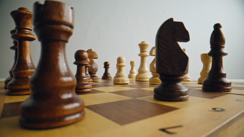 Closeup of hand playing chess game to development analysis strategy plan. Person shifting dark figure on checkered platform changing with opposing unit at white room alone. Leader and teamwork concept - Powered by Shutterstock - Get 15% off with code: PIKWIZARD15