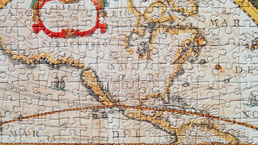 Overhead perspective completed puzzle showing old world map. Vintage style jigsaw with detailed geographic terrain closeup. Smooth camera movement capturing antique cartographic game pieces together