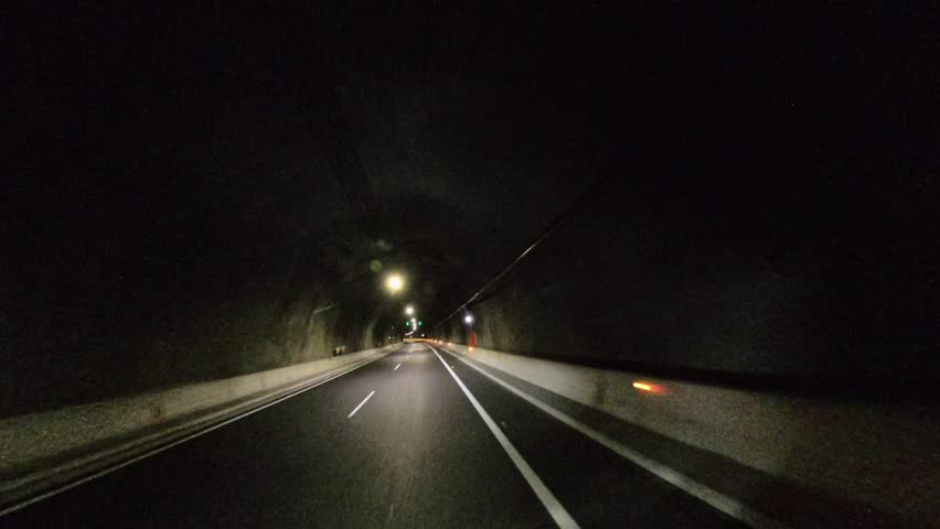 Driving through tunnel on GC-2 highway in Gran Canaria, Spain, filmed in 360 video from moving car, straightforward perspective, bright tunnel lights, smooth motion, Canary Islands travel footage
