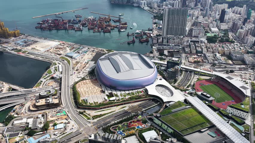 Hong Kong Kai Tak Sports Park includes a world-class multi-purpose main venue with retractable canopy and coastal dining area by seaside Victoria Harbour connected Station Metropolitan Park
