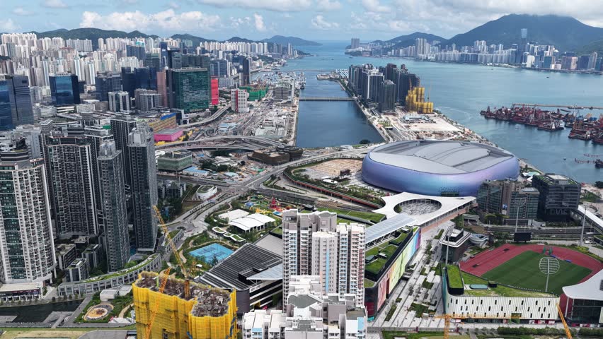 Hong Kong Kai Tak Sports Park includes a world-class multi-purpose main venue with retractable canopy and coastal dining area by seaside Victoria Harbour connected Station Metropolitan Park