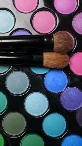 Professional makeup eyeshadows palette and brushes for make-up artist, closeup. Rotation. Vertical footage