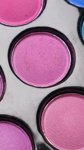 Taking color from Professional makeup eyeshadows palette for make-up artist, closeup. Vertical footage