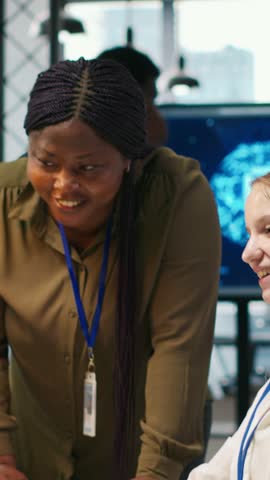 Vertical video Happy manager praising intern progress with encouraging words, doing congratulating high five. Smiling team leader providing positive feedback for young female engineer at work, camera