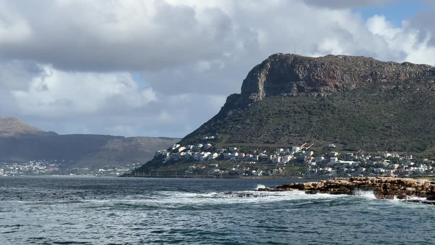 The view from the wall at Kalk Bay harbour towards Fish Hoek and Simon’s Town near Cape Town, South Africa.