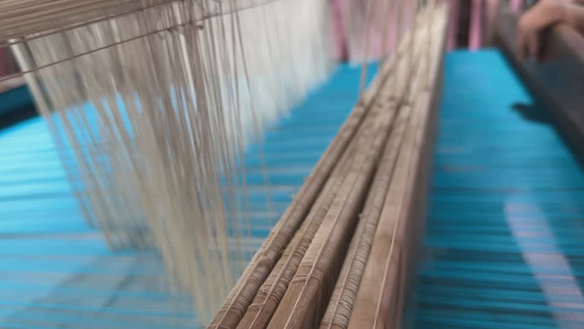 Closeup of various threads used in the handloom textile handloom to create a fabric