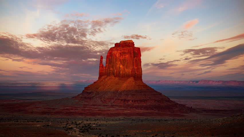 Cinemagraph at Monument Valley, East Mitten Butte. Desert time lapse, glowing in the evening sun, passing clouds.