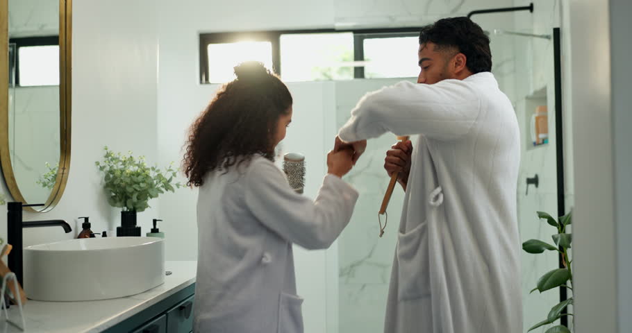 Dancing, couple and karaoke in bathroom, play and sing with brush in home, silly or morning routine. Happy, man and bonding with woman in house, romance and people with rhythm, smile or getting ready