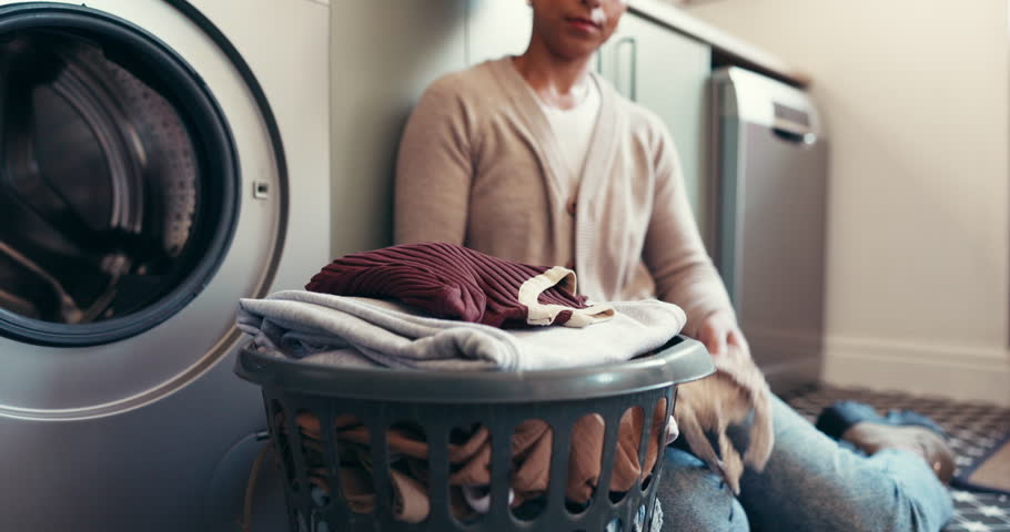 Folding, laundry and person with chores, home or organizing clothes in apartment, basket or routine. Spring cleaning, hands and arrangement of tidy linen, sorting and cleaner with finished housework