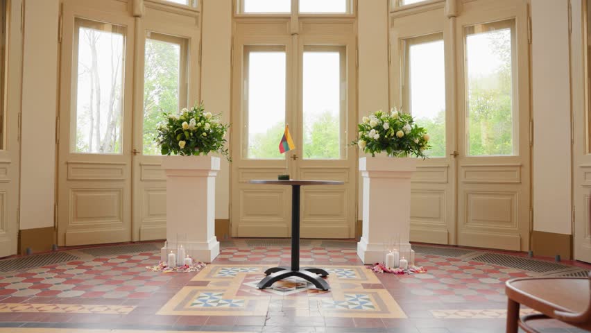 Beautiful wedding venue with decorated chairs and floral arrangements in a sunlit room stunning visuals dynamic movement cinematic quality rich detail