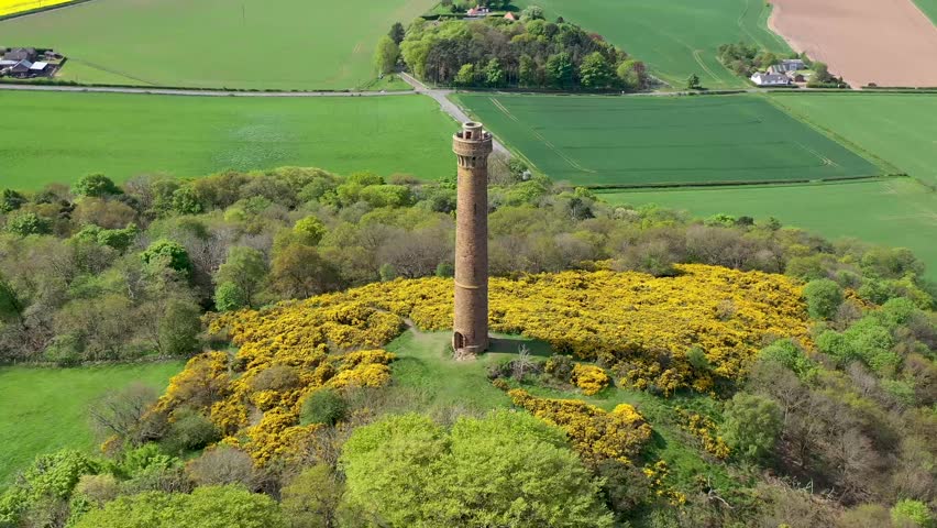 Aerial view of Hopetoun Monument surrounded by countryside and trees, Scotland.