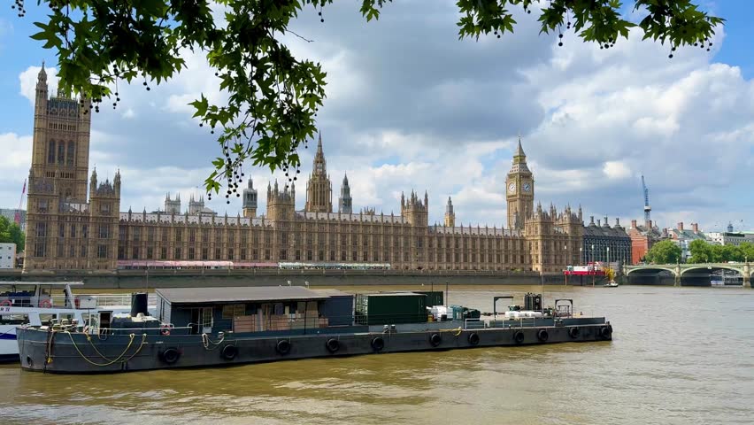 Big Ben and Houses of Parliament stand majestically by the River Thames