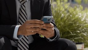 businessman sitting outside city offices looking mobile phone with motion graphics emojis showing messaging. social media notifications. Outdoor, man male hands with smartphone for network, connection - Powered by Shutterstock - Get 15% off with code: PIKWIZARD15