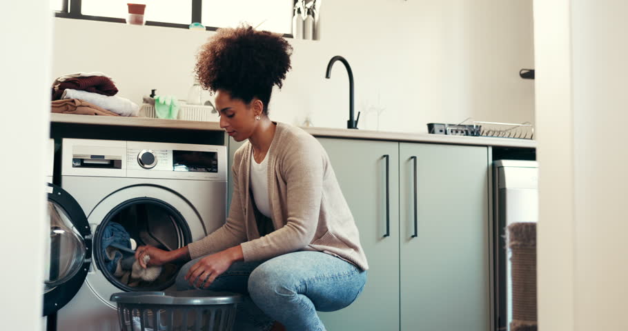 Clothes, basket and cleaning with woman and washing machine for fabric, hygiene and linen. Laundry, housekeeping and cloth with person in washroom of home for cleaner, dryer and domestic chores