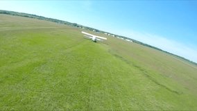 Airplane riding along rural runway before the take-off. Old aircraft heading towards airstrip for before flight at airfield. Retro plane preparing to fly. Aviation concept. Aerial shot from drone - Powered by Shutterstock - Get 15% off with code: PIKWIZARD15