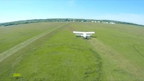 Airplane riding along rural runway before the take-off. Old aircraft heading towards airstrip for before flight at airfield. Retro plane preparing to fly. Aviation concept. Aerial shot from drone - Powered by Shutterstock - Get 15% off with code: PIKWIZARD15