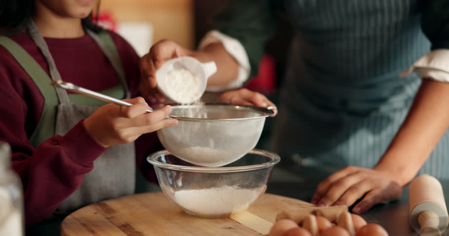 Dad, girl and hands with sifting for flour with cooking, teaching and ingredients for cookies in home. African people, father and daughter in kitchen, learning and sieve for baking with family