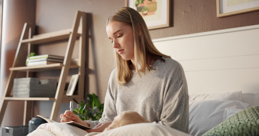 Thinking, woman and writing notes on bed for planning, reminder and reflection for self care. Female person, puppy and notebook for checklist, inspiration ideas and journaling of information at house