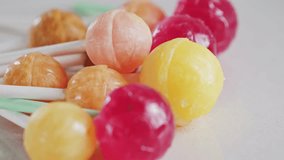 Bright colorful candies, lollipops on a white background rotating close-up. High quality 4k footage - Powered by Shutterstock - Get 15% off with code: PIKWIZARD15