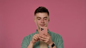 A man wearing yellow sunglasses scrolls through the feed on his smartphone and wonders at the pink background, creating a stylish and fashionable studio atmosphere. - Powered by Shutterstock - Get 15% off with code: PIKWIZARD15