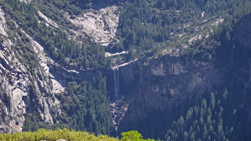 Footage capturing Vernal Fall as seen from a high-elevation viewpoint at Glacier Point in Yosemite National Park, California
