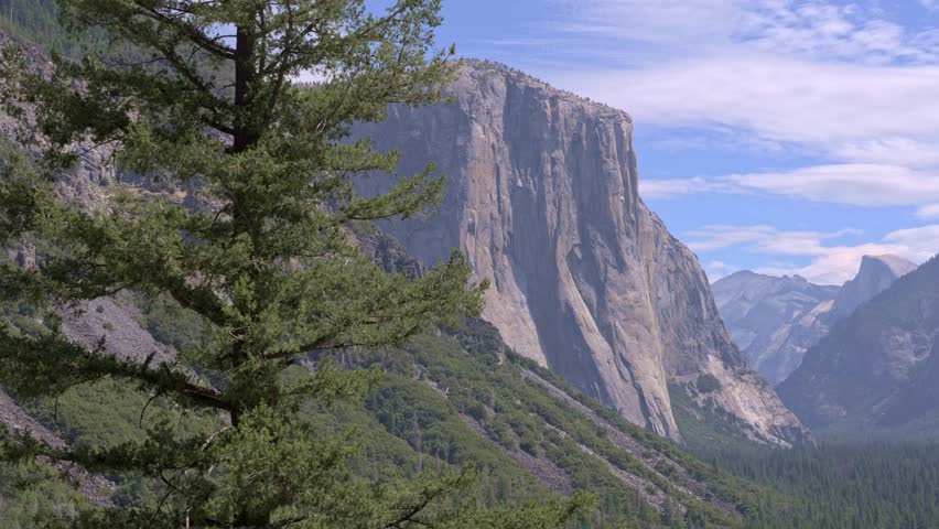 Footage featuring a panoramic pan shot from Tunnel View in Yosemite National Park, California. El Capitan, Half Dome, and Bridalveil Fall are visible