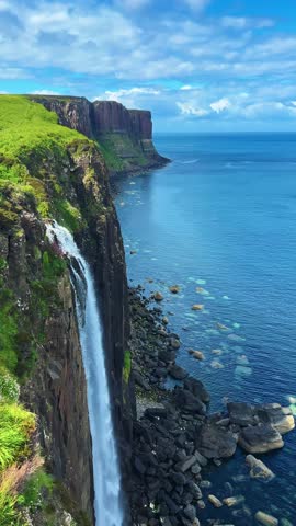 Mealt Waterfall With Kilt Rock In The Background In Isle of Skye, Scotland. - vertical shot