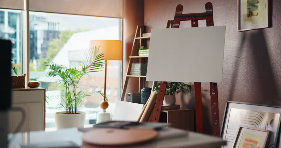 Creative, canvas and empty art studio with furniture, painting supplies or plants in home. Easel, interior and set up for artwork in workshop or workspace with display, decoration or design.