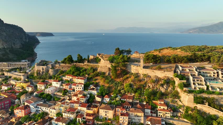 High-resolution morning aerial view of Nafplio’s old town, showcasing charming narrow streets, traditional homes, and the deep blue coastline.