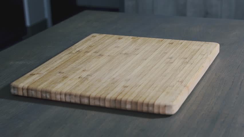 Various sized kitchen knives for cutting meat and vegetables on a board