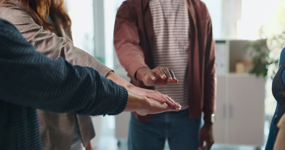 Hands together, teamwork and community with business people in office for mission, synergy or trust. Partnership, collaboration and inclusion with group of employees in agency for support and respect