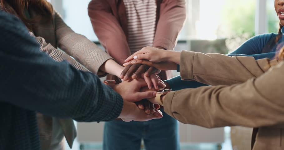 Hands together, teamwork and community with business people in office for mission, synergy or trust. Partnership, collaboration and inclusion with group of employees in agency for support and respect