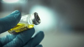 A healthcare professional is filling a syringe with a vaccine from a glass vial. The setting is a clinical environment with an emphasis on safety and precision - Powered by Shutterstock - Get 15% off with code: PIKWIZARD15