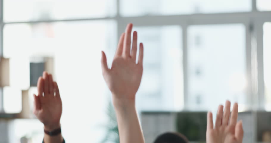 Business people, hands raised and meeting with question for engagement or interaction in office. Group, employees or team with answer for unity, solidarity or participation together in workplace