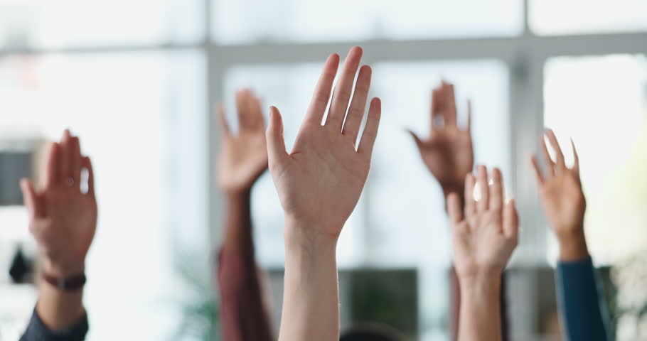 Business people, hands raised and meeting with question for engagement or interaction in office. Group, employees or team with answer for unity, solidarity or participation together in workplace
