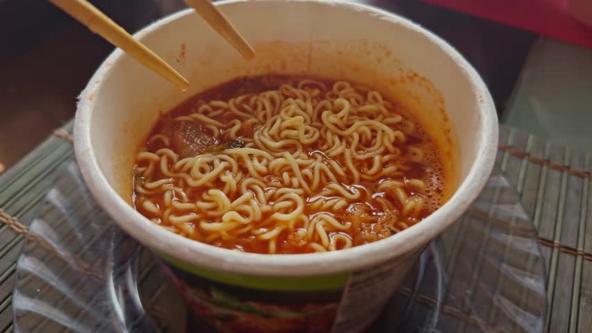 Tasty spicy Asian noodle bowl. Instant Noodles Bowl. Eating Chinese Ramen Soup. Cooked Delicious Instant Noodles With Vegetables. Asian Dinner Cooking. Quick Ramen With Dry Vegetables. Chinese Food