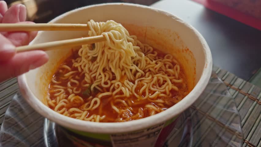 Tasty spicy Asian noodle bowl. Instant Noodles Bowl. Eating Chinese Ramen Soup. Cooked Delicious Instant Noodles With Vegetables. Asian Dinner Cooking. Quick Ramen With Dry Vegetables. Chinese Food