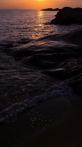 Vertical View of Sunset Above Sea, Light Waves and Coastline